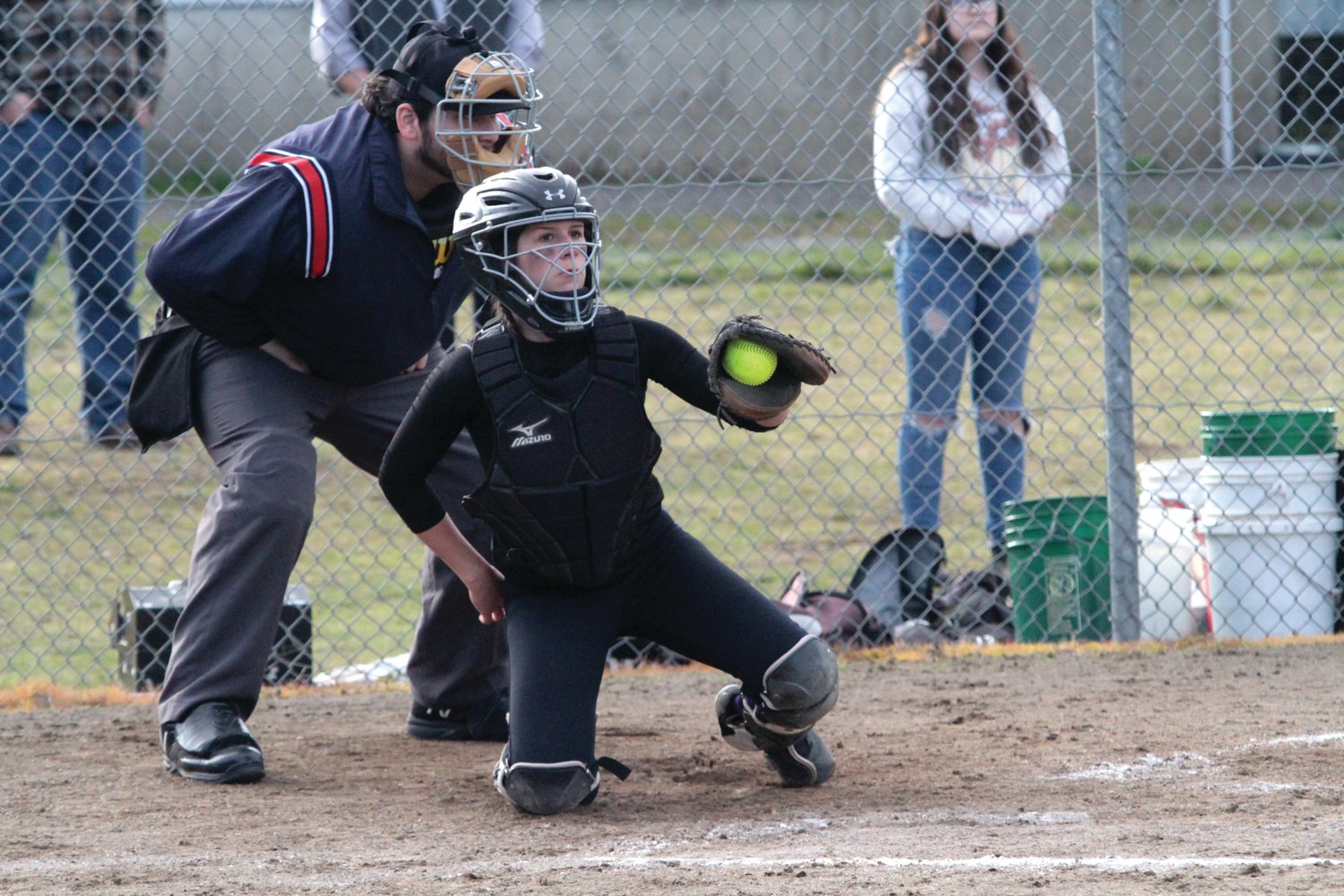 Stormie Elkins keeps an eye on the runner at first base during Quilcene’s fastpitch softball game last week against Darrington. Leader photo by Brian Kelly